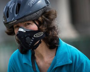 woman-wearing-anti-pollution-mask-rides-bicycle-hyde-park-corner