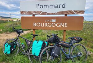 Deux vélos sont posés devant le panneau d'entrée dans le village de pommard en bourgogne.