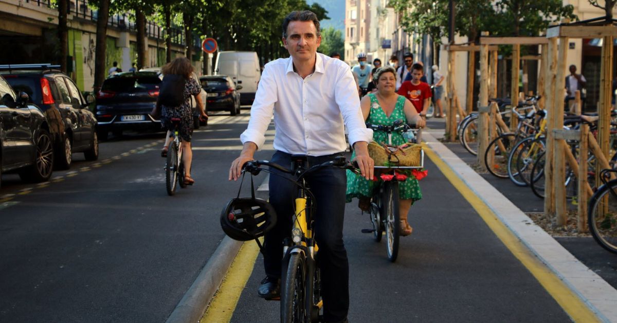 Éric Piolle à vélo sur une piste cyclable à Grenoble, engagement politique pour les municipales 2026 à vélo